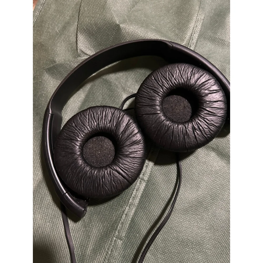 These are a pair of black Sony on-ear wired headphones. The earcups feature the